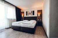 A bed or beds in a room at Pension Baumgartner-Berghof