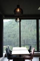 a table and chairs in front of a large window at Cone Hotel Dilijan, By One in Dilijan