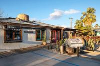 a store front of a building with a palm tree at Ramsey 29 in Twentynine Palms