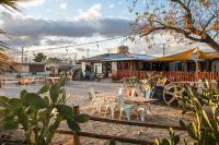 a patio with tables and chairs and a building at Ramsey 29 in Twentynine Palms