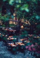 a restaurant with tables and chairs in a garden at InterContinental Century City Chengdu in Chengdu