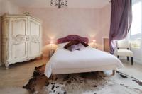 a bedroom with a large white bed and a dresser at Logis Hotel Des Bains in Gérardmer
