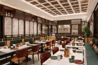 a restaurant with tables and chairs and windows at Shangri-La Fuzhou in Fuzhou