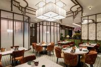 a restaurant with tables and chairs and a chandelier at Shangri-La Fuzhou in Fuzhou