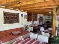 a restaurant with two tables and two beds in a room at Kemal's Guest House in Goreme