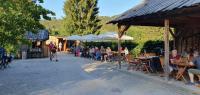 a group of people sitting at tables in a restaurant at Ferienhäuser & Bungalows - Naturcamp Meyersgrund im Thüringer Wald in Ilmenau