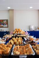 Un buffet de pasteles y otros alimentos en exposición. en Hot Star Thermas Hotel, en Caldas Novas