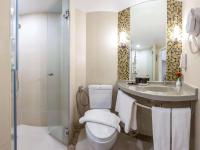 a bathroom with a toilet and a sink and a shower at Ibis Phuket Patong in Patong Beach