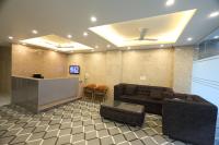 a living room with a couch and a bar at Westay Suites in Gurgaon