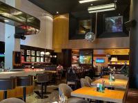 a restaurant with tables and chairs and a bar at Autentico Monterrey in Monterrey