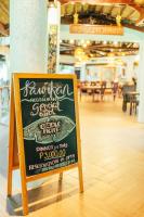 a chalkboard sign in a room with a restaurant at Daluyon Beach and Mountain Resort in Sabang
