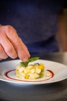 a person picking up a piece of fruit on a plate at Oh Activ Cergy in Cergy