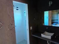 a bathroom with a sink and a mirror at Pousada ZEN Cumuruxatiba in Cumuruxatiba