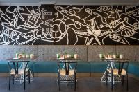 een restaurant met twee tafels en een muurschildering bij The Rockley by Ocean Hotels - Breakfast Included in Bridgetown