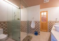 a bathroom with a shower and a toilet and a sink at England B&amp;B in Luodong
