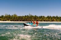two people on a jet ski in the water at Hidden Beach Resort Au Naturel Adults Only Catamarán, Cenote & More Inclusive in Akumal