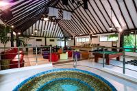 a pool in the middle of a room with ping pong tables at Hidden Beach Resort Au Naturel Adults Only Catamarán, Cenote & More Inclusive in Akumal