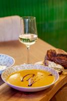 a plate of food and a glass of wine on a table at Apt with best rated breakfast ZAP B&B in Split