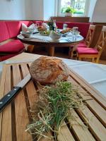 a table with a cutting board with a loaf of bread at Brauhotel Weitra in Weitra