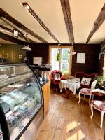 a restaurant with a counter and a table and chairs at Kvistrom Inn - Kviströms Gästgiveri in Munkedal