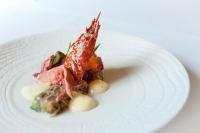 a white plate with a piece of food on it at Château de Saulon in Saulon-la-Rue