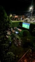 Una vista de un jardín de noche con piscina. en Golden Age Hostel, en Ohrid