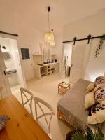 a living room with a bed and a dining room table at Walk The View Apartment with village view in Chora in Ios Chora