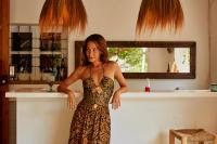 a woman in a dress standing in a kitchen at Valley Club Ibiza - Boutique Agroturismo in Sant Joan de Labritja
