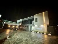 a building with a parking lot in front of it at night at Choice Grande Lagos in Ikeja