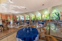 a banquet hall with blue tables and chairs at Gran Karmel Hotel in Santa Cruz Muluá