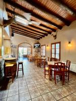 a kitchen and dining room with tables and chairs at Posada OsTablaus in Longás