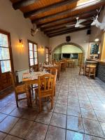 a dining room with wooden tables and chairs at Posada OsTablaus in Longás