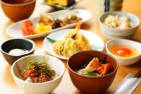 a table with bowls of food and plates of food at AMANEK Beppu YULA-RE in Beppu