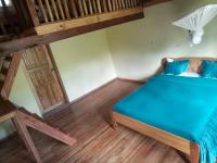 a small room with a bed and a loft at Soanala in Moramanga