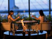 a fire pit on a table with two women in the background at ReLabo -Medical Spa & Stay- in Aomori