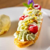 a piece of bread with cream cheese and fruit on it at Hôtel SPA du Lac de Madine - Maison DRAPIER in Heudicourt-sous-les-Côtes