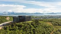 an aerial view of a building on a hill with trees at Wood Hotel Bodø in Bodø