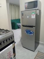 a refrigerator and a stove in a room at Homes by Deuces in Ngong