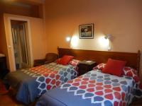 A bed or beds in a room at Hostal San Martin