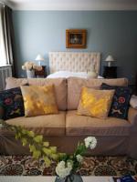 a living room with a couch and a bed at Vila Adelaide in Brtníky