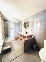 a bathroom with a sink and a mirror at The volcano in Kubupenlokan