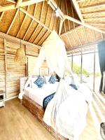 a bedroom with a bed with a hammock in it at The volcano in Kubupenlokan