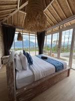 a large bed in a room with windows at The volcano in Kubupenlokan
