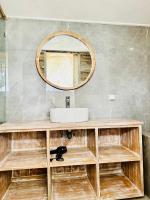 a bathroom with a sink and a mirror at The volcano in Kubupenlokan
