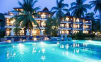 a hotel with a swimming pool in front of a building at Maehaad Bay Resort - SHA Plus in Mae Haad