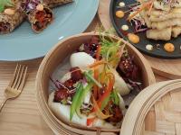 a bowl of food on a table with plates of food at GY BOUTIQUE HOTEL in Glenorchy