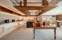 a restaurant with a table and chairs in a room at UrCove By HYATT Chengdu Wenshu Monastery in Chengdu