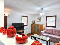 a living room with red vases and a couch at Sarajevo Pine Hideaway - Free Private Parking in Sarajevo