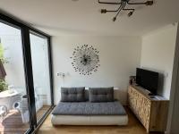 a living room with a couch and a tv at Cosy Splendor &#47; City Center in Graz