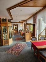 a living room with a table and chairs at Seehotel Andree & Gästehaus Seehof in Waldeck